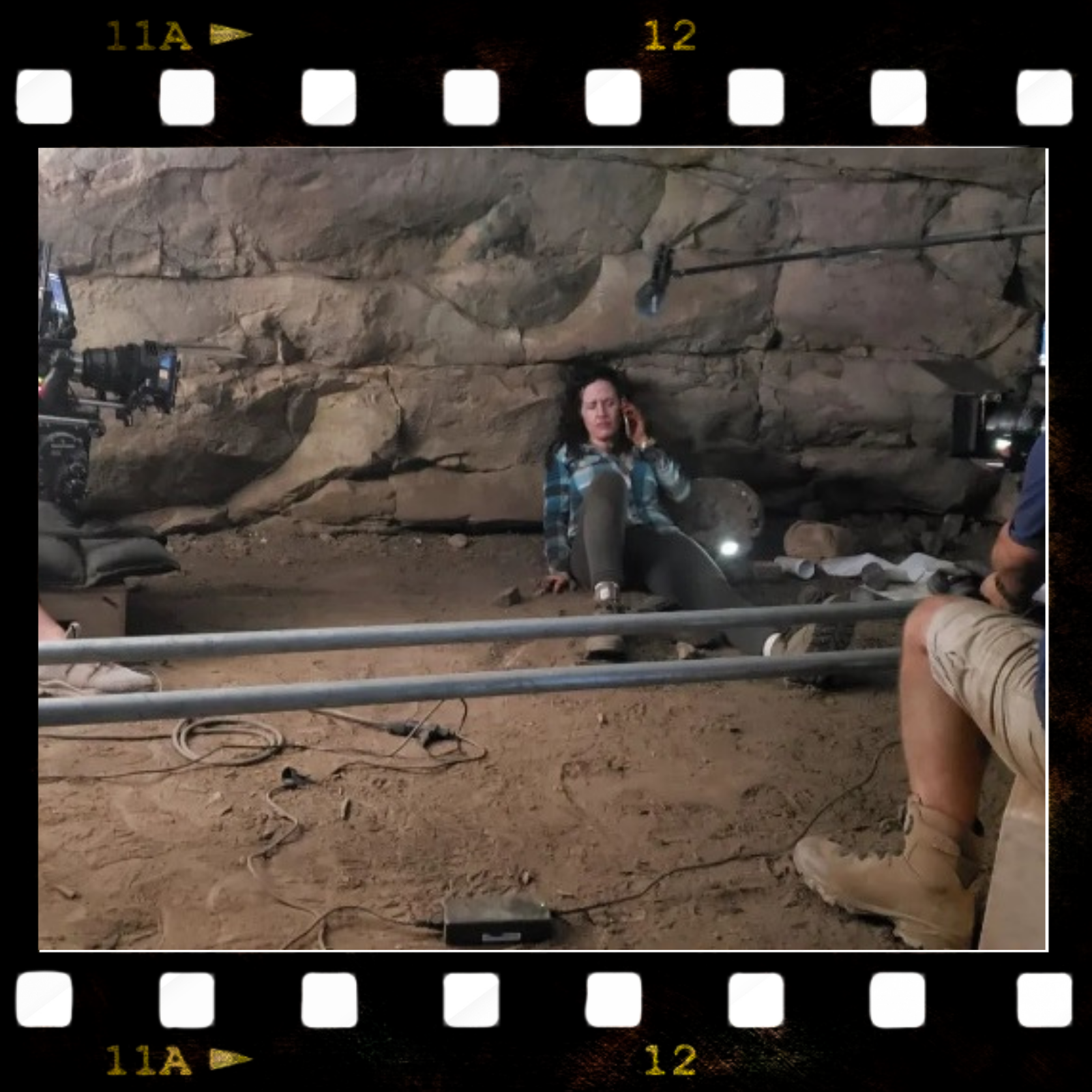 Annie Malee shown on the floor of a real cave in a behind-the-scenes photo on the set of the "Abandonment" film. 